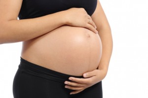 woman holding her own pregnant belly