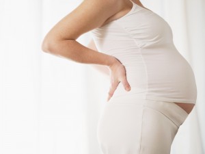 pregnant woman wearing white in profile